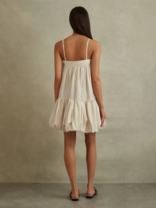 Chic backless cream white mini dress with thin straps and ruffled bubble hemline