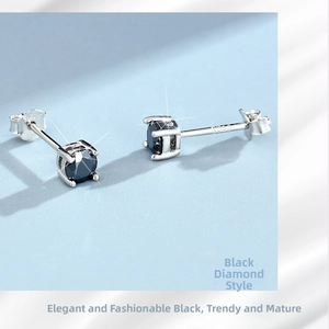Detailed macro view of S925 sterling silver four-prong stud earrings with black round gems
