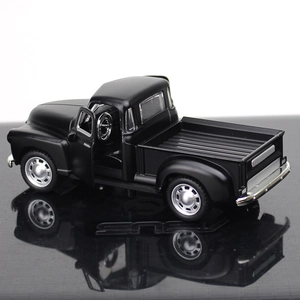 Detail of vintage black alloy pickup model with opening doors and metallic finish