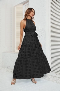 Detail of black plaid halter dress featuring a tiered cake skirt and matching waist tie