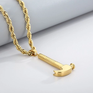 Detail of gold claw hammer pendant with twisted rope chain made of polished stainless steel