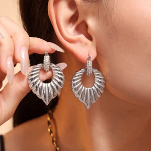 Elegant silver leaf-shaped earrings with rhinestones on a model for a realistic look