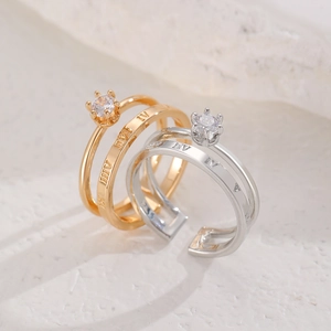 Detailed view of adjustable crown ring set with roman numerals and six-prong zircon