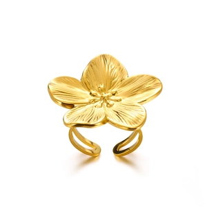 Detailed close-up of a vintage golden flower ring with polished stainless steel finish