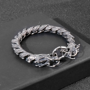 Macro view of vintage silver steel dragon bracelet with oxidized texture and scale carving