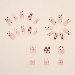 French ballet press-on nails with cow print and brown heart patterns on a pink base