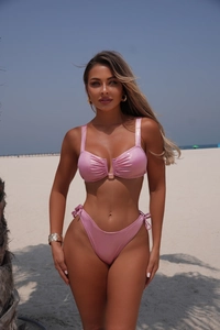Close-up of pink glitter fabric texture and V-neck detail on a two-piece bikini