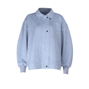 Detail of light blue long-sleeved polo jacket with oversized pockets and button closure