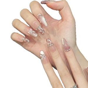 Sparkly pink cat eye press-on nails in long coffin shape with 3D butterfly and pearls