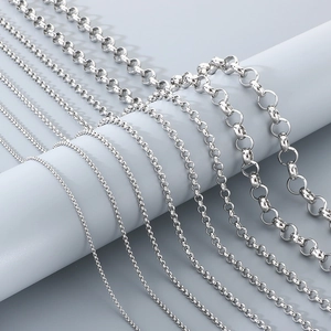 Multiple sizes of minimalist stainless steel pearl link chains displayed on grey stand