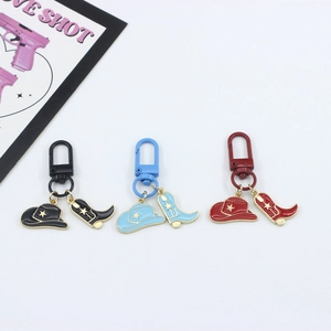 Three western cowboy keychain sets with enamel hat and boot charms in red blue and black