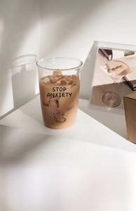 Detail of high borosilicate glass cup with cartoon dog and Stop Anxiety text