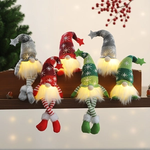 Three glowing Christmas gnomes with LED lights, knitted star hats on a festive background
