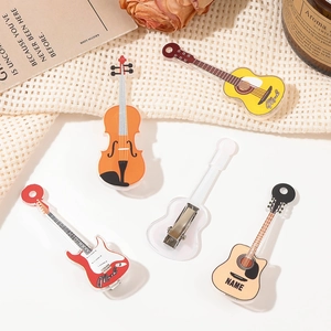 Close-up of guitar and violin shaped acrylic hair clips on a white artistic background