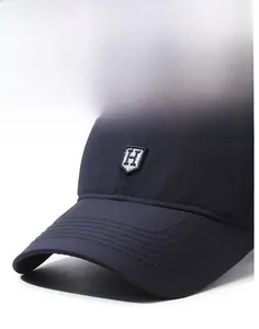 Close-up of navy blue baseball cap with shield-shaped H embroidery and reinforced brim