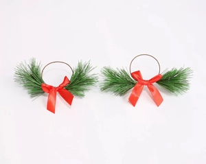 Close-up of PVC pine needle napkin rings with red bows for Christmas table decor