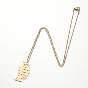 Detailed close-up of golden trumpet pendant necklace on elegant thin metal link chain