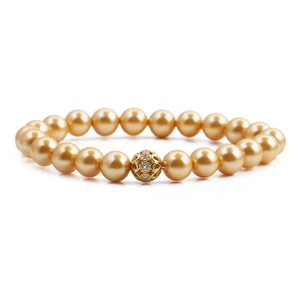 Elegant gold pearl bracelet featuring a central hollow engraved metallic bead on white background