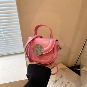 Detail of pink mini shoulder bag featuring a textured silver metal buckle and PU leather