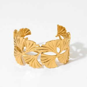Golden wide open cuff bracelet with hollow ginkgo leaf design and brushed metal finish