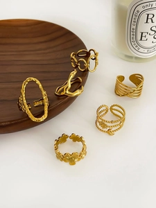 Set of six gold plated stainless steel rings featuring flower moon and chain designs