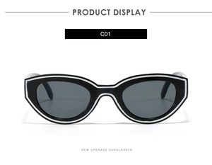 Detail view of retro cat-eye sunglasses featuring black frames and white geometric line trim