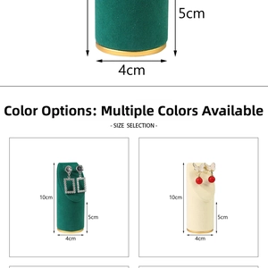 Macro detail of cylinder earring display stands in green and beige with gold metal base