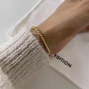 Minimalist 925 sterling silver golden bead bracelet shown on wrist for a French chic look