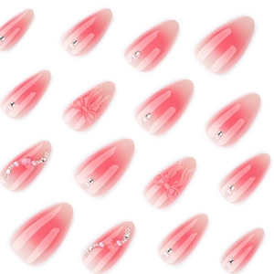 Pink gradient press-on nails featuring 3D bow, silver beads, and pearls in almond shape