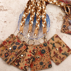 Cork card holder sets with patterns and woven wrist straps displayed on stone surface