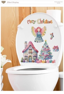 Close-up of pink watercolor Christmas house and tree decals applied on a white surface