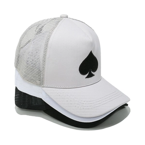 Detail shot of mesh trucker hat with spade embroidery and breathable white mesh