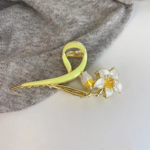 Detailed view of floral hair claw clip featuring tulip petals and pearl accents