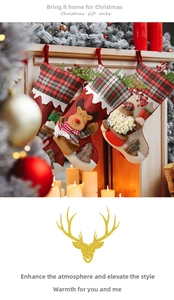 Detail of Christmas stocking with 3D reindeer embroidery and red plaid on a cozy mantle