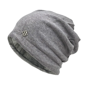 Stylish dark grey knitted slouchy beanie with silver metal logo patch for winter