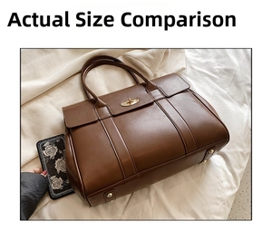 Detailed close-up of a vintage brown leather tote with a gold twist lock for business