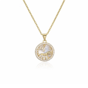 Detailed shot of gold plated zodiac necklace featuring a Scorpio pendant with MOP inlay