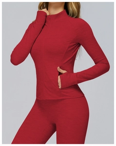 Close-up of red athletic jacket featuring thumbholes and functional side zipper pockets