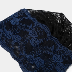 Detailed view of dark blue rose embroidery lace with black mesh on a breathable beanie cap