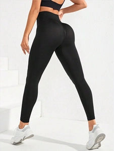 Detail of high waisted black yoga leggings showing seamless contour and peach lift fit