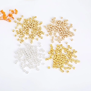 Detailed macro view of 18K gold plated cube spacer beads for DIY jewelry making