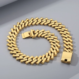 Detailed close-up of 20mm gold-plated stainless steel Cuban link bracelet and buckle