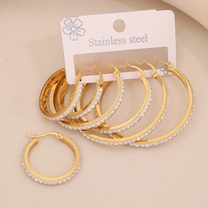Three pairs of golden stainless steel hoop earrings with sparkling rhinestones set