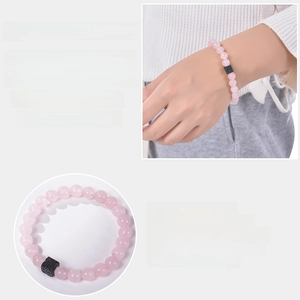 Detail of 8mm pink crystal beaded elastic bracelet with black square volcanic stone charm