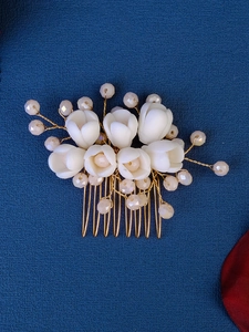 Detail of handmade bridal hair comb with white ceramic tulips and pearl accents