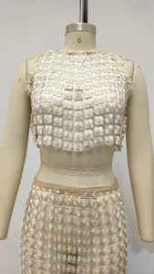 Detail of 3D floral appliqué texture on ivory two-piece crop top and maxi skirt set
