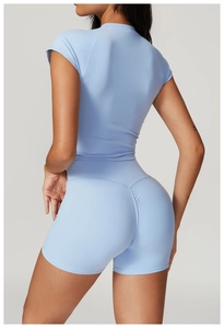 Close-up of light blue high-waist shorts with ruched seam for scrunch butt lifting effect