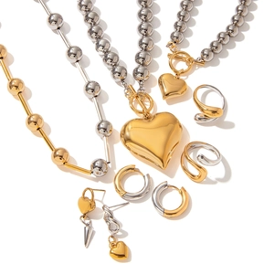 Elegant two-tone stainless steel jewelry set with heart pendants and OT buckle design