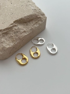 Macro view of geometric 925 sterling silver earrings in gold and silver finishes