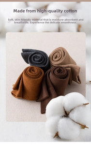 Detail of four pairs of high-quality cotton socks in grey, brown, and earth tones
